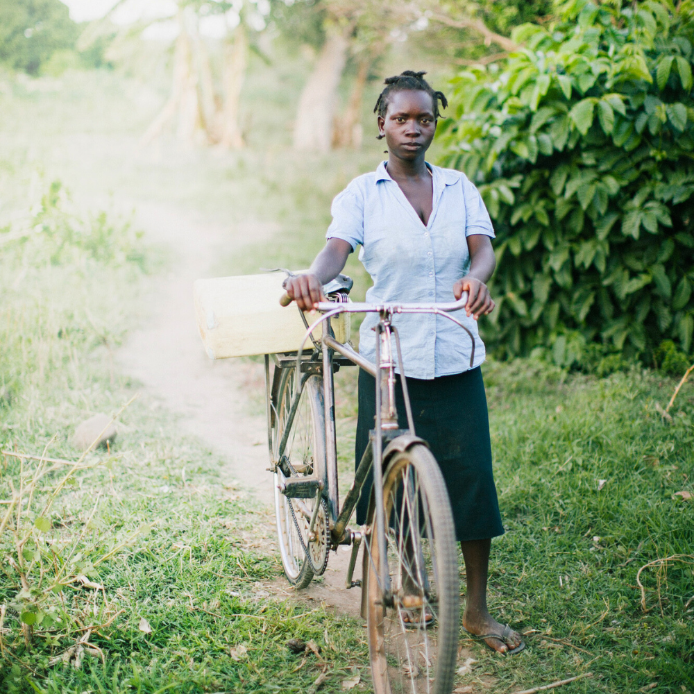 A woman with a bicycle.
