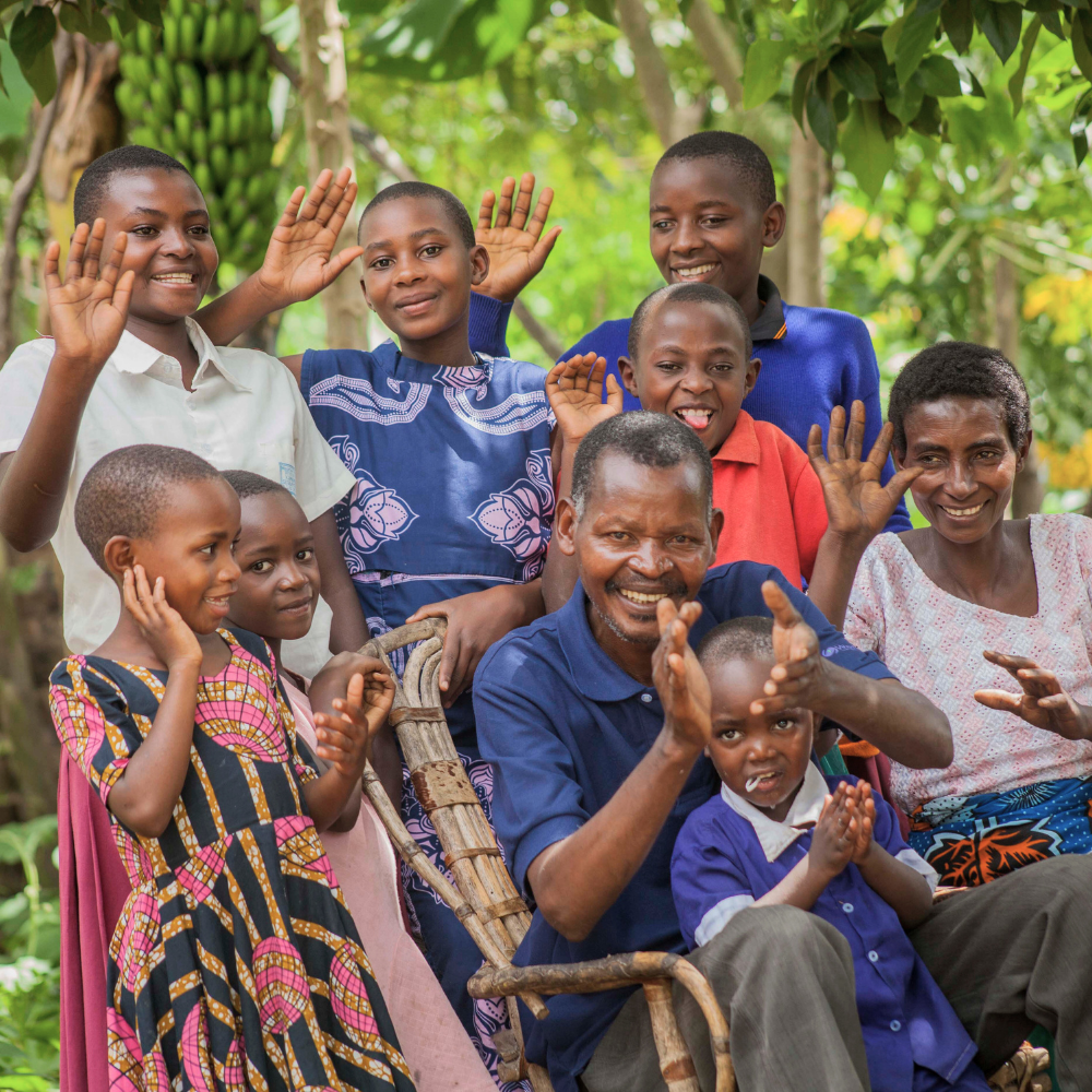 A family sits together and waves