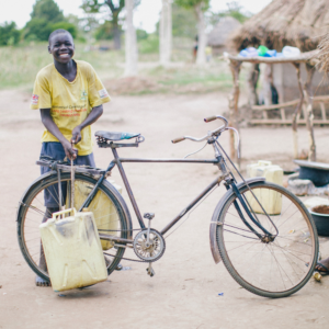A child with a bicycle.
