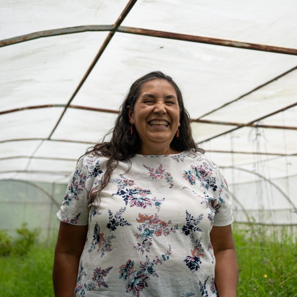 woman standing in a greenhouse