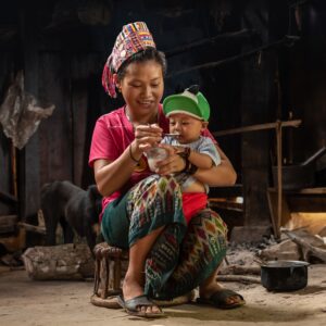 mother spoon-feeding infant