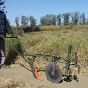 Direct seeder farming tool positioned in a field.