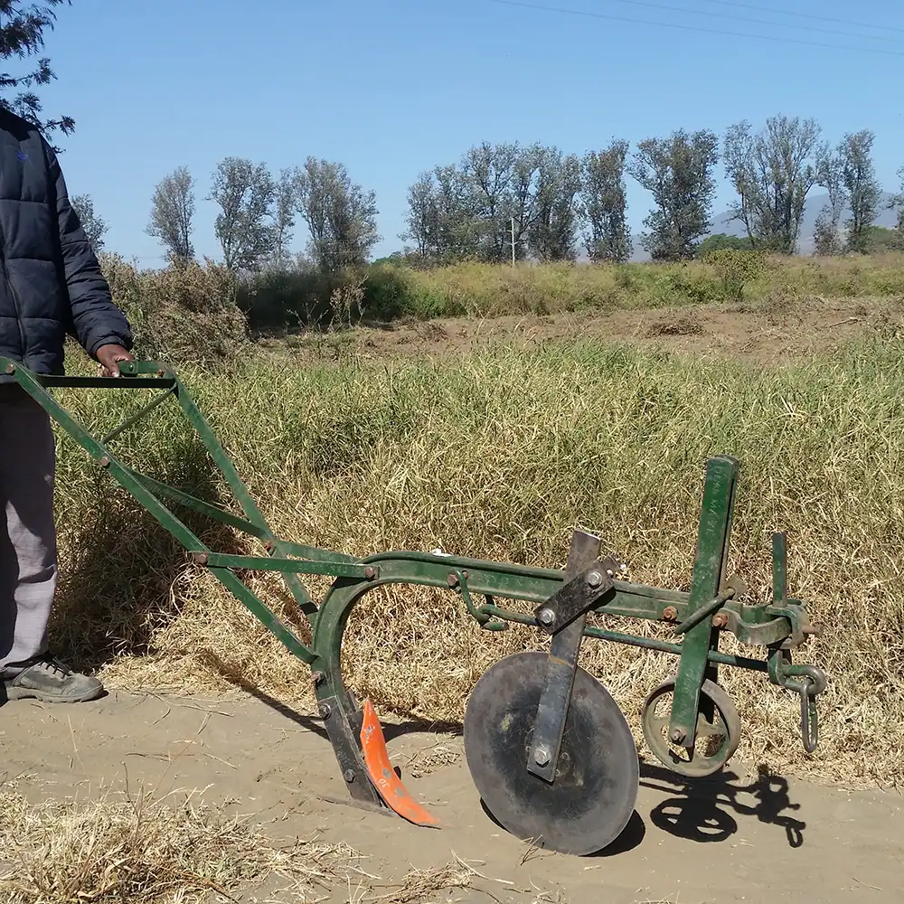 Direct seeder farming tool positioned in a field.