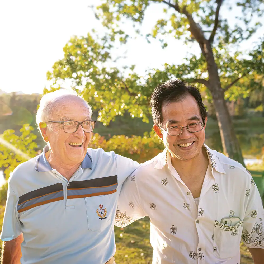 Two people standing together outdoors.